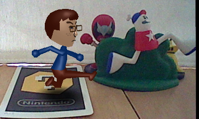 A picture of a Nintendo Mii version of Tylor Lilley running next to a running Homestar figure, taken with a Nintendo 3DS and AR card