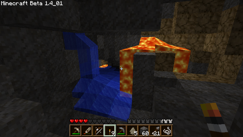A screenshot of a water following into lava in a cave in Minecraft.