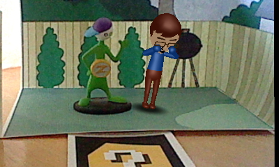 A picture of a Nintendo Mii version of Tylor Lilley crying in a diorama with a Coach Z figure, taken with a Nintendo 3DS and AR card