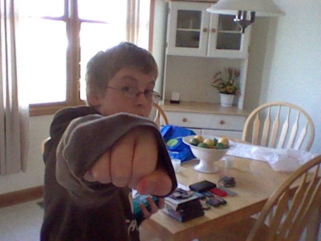 A picture of Carter Lilley at age 12 with his fist extended toward the camera, taken with a Nintendo 3DS